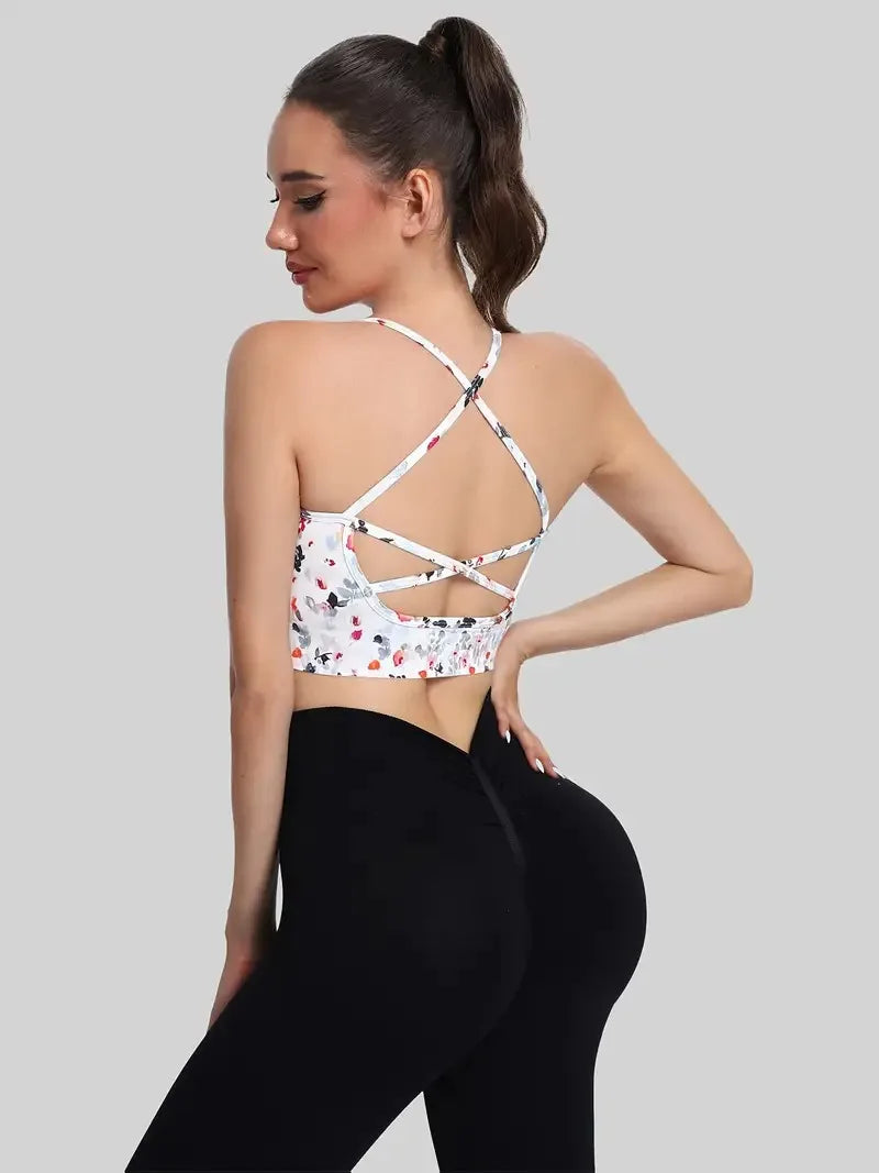 Top esportivo feminino com alças cruzadas nas costas e estampa floral